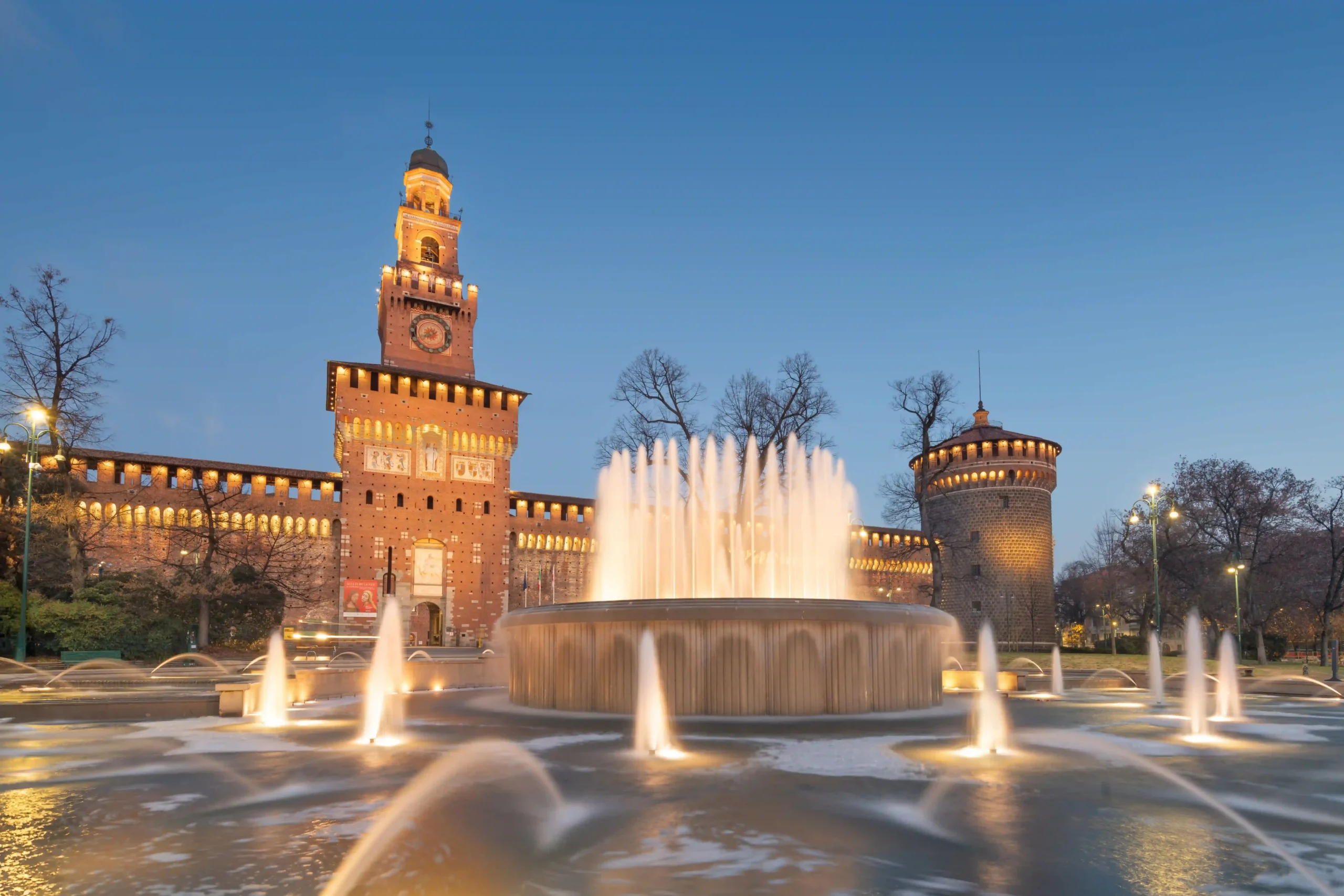 In the picture, an evening view of the fountain outside Sforzesco Castle.